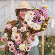 Load image into Gallery viewer, Bellingham Florist, Laura Wheeler, holding pink bouquets for delivery
