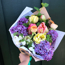 Load image into Gallery viewer, Gorgeous and colorful spring bouquet with tulips, lilac, dogwood, ranunculus, and geum flowers.