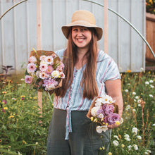 Load image into Gallery viewer, Laura holding a large and medium bouquet of pink summer flowers grown in her city lot garden.