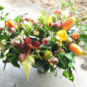 Gorgeous spring compote in "Warm" palette tulips, ranunculus, fern, flowering shrubs, mock orange, and other spring blooms. Laura grows, arranges, and delivers flowers to the local Bellingham community and surrounding areas every season of the year.
